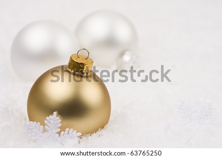 Gold and white Christmas baubles in snowflake garland.