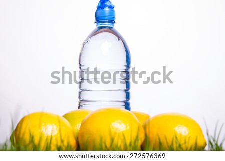 Mineral water bottle and lemon