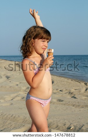 happy child eat ice cream on beach