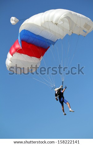 extreme sport parachutist on blue sky