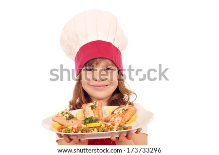 happy little girl cook hold plate with salmon seafood