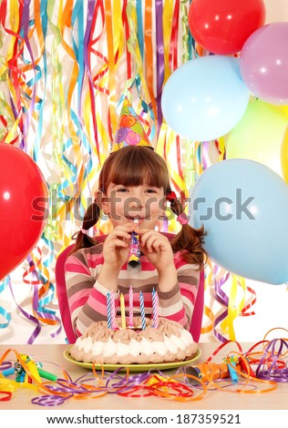 happy little girl with trumpet and cake birthday party