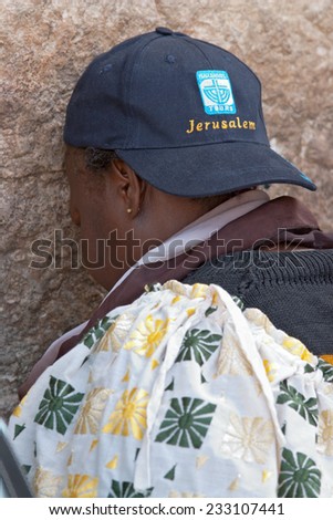 JERUSALEM, ISRAEL-MARCH 14, 2006:A woman prays at the Wailing Wall. The Western Wall, Wailing Wall or Kotel is located in the Old City of Jerusalem at the foot of the western side of the Temple Mount.