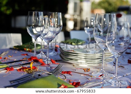 Wedding table set outdoor.\\
Table decorated for the wedding party covered with beautiful red flowers.
