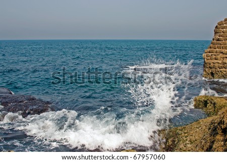 Wave and sea foam on the shore of the Mediterranean Sea.