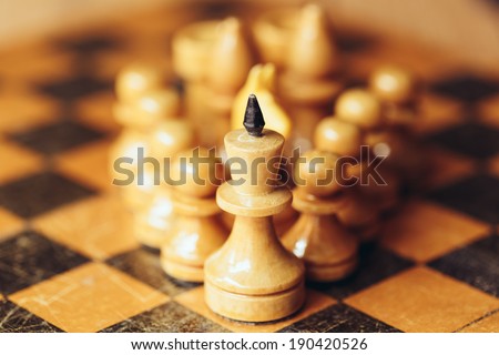 Chess leader led king his army white wooden figures. Concept game
