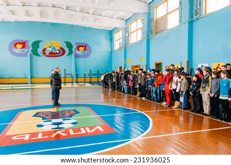 GOMEL, BELARUS - JANUARY 1, 2011: Unrecognizable Belarusian secondary school pupils lined up in the school gym before the winter ski competitions.