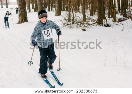 GOMEL, BELARUS - JANUARY 1, 2011: Unrecognizable Belarusian secondary school pupil preparing for school winter ski competitions \