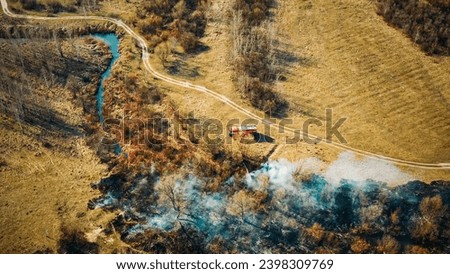 Similar – Image, Stock Photo Aerial View. Spring Dry Grass Burns During Drought Hot Weather. Bush Fire And Smoke In Forest. Wild Open Fire Destroys Grass. Nature In Danger. Ecological Problem Air Pollution. Natural Disaster.