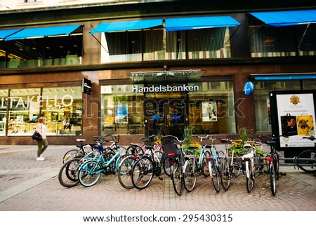 HELSINKI, FINLAND - JULY 28, 2014: View of Kluuvikatu street. Parked Bicycles On Sidewalk.