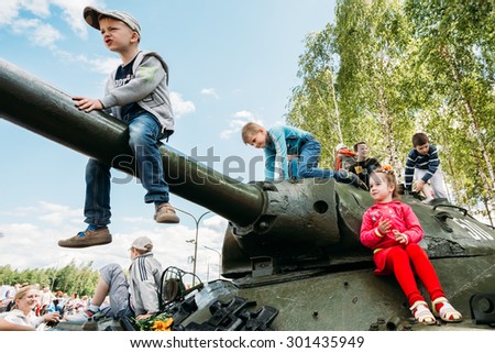 SVIETLAHORSK, BELARUS - JUNE 21, 2014: Children climb on Soviet tank from World War II during celebration events dedicated to 70th anniversary of Soviet Belorussian offensive operation \