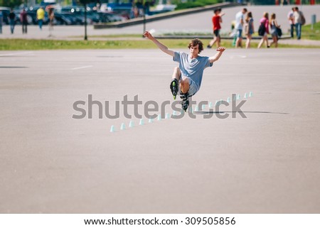 MINSK, BELARUS - June 2, 2015: Young man roller on rollerblades driving in park in district Nemiga, Nyamiha in Minsk, Belarus.