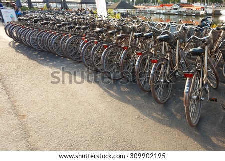STOCKHOLM, SWEDEN - JULY 30, 2014: Row of city parked bicycles bikes for rent on sidewalk. Bike Bicycle Parking In European City