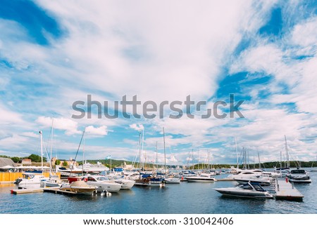 OSLO, NORWAY - JULY 31, 2014: View of Embankment In district Aker Brygge in Oslo, Norway. Summer Evening. Aker Brygge is a popular area for for shopping, dining, and entertainment.