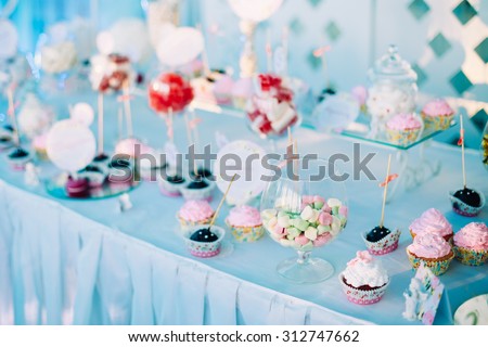 Various Dessert Sweet Cupcakes, Candy, confection On Table. Sweets. Candy bar. Sweet holiday buffet with cupcakes and other desserts