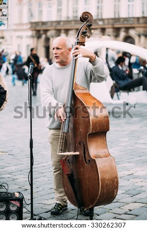 PRAGUE, CZECH REPUBLIC - OCTOBER 10, 2014: Street Busker performing jazz songs at the Old Town Square in Prague. Busking is legal form of earning money on Prague Streets.