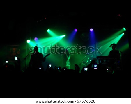Backlit concert scene with band on stage