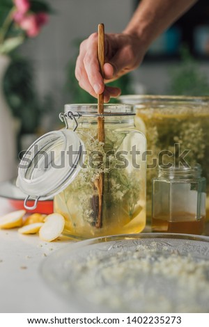 Similar – Image, Stock Photo Elder flower syrup ingredients: Elder branch, lemon and sugar in glass jar