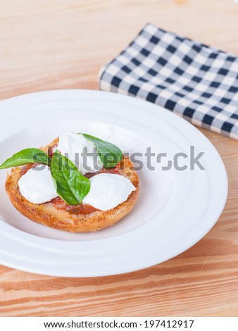 pie with cream cheese, red sauce and basil on wood table