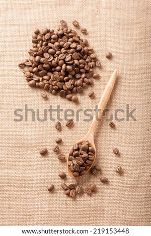 Light roasted coffee beans on sackcloth.