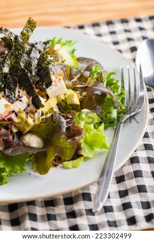 Japanese salad with tofu, avocado, seaweed and wasabi mayonnaise.
