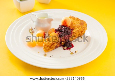 Cheese toast topped with blueberry sauce with ice cream cantaloupe and melon sauce