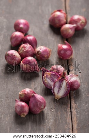 Shallots (red onion) set up on wood table with low key scene.
