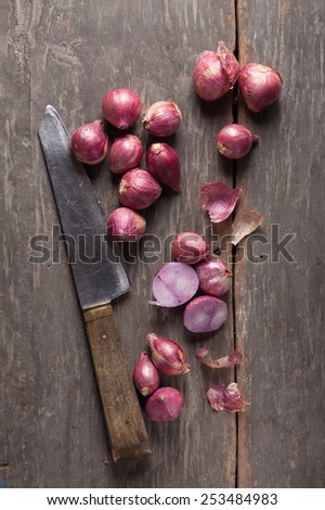 Shallots (red onion) set up on wood table with low key scene.