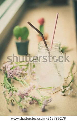 Italian soda on wood bar in cafe with film filter effect