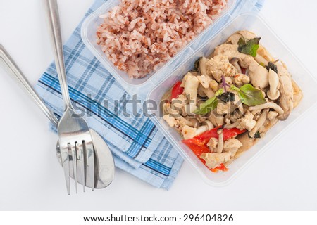 Stir fried basil with chicken breast and Termitomyces cooked by clean food concept with brown rice in lunch box