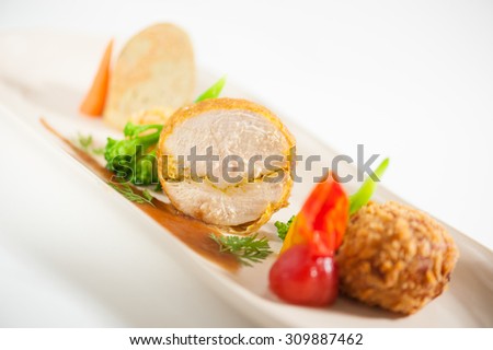 3 modern cuisine Prosciutto Wrapped Chicken with resotto and tamarind sauce, Fried mussaman curry, and Thai chicken spicy sausage on ceramic dish garnished with vegetables