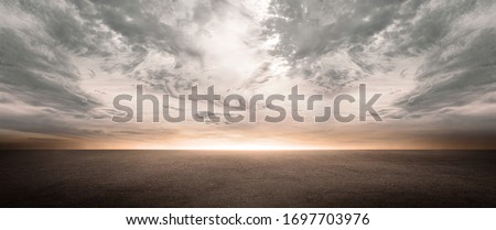 Dark Concrete Floor Background with Scenic Night Sky Horizon and Dramatic Clouds