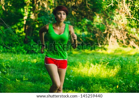 beautiful healthy brunette young woman athlete running outdoors, fitness and a healthy lifestyle, running