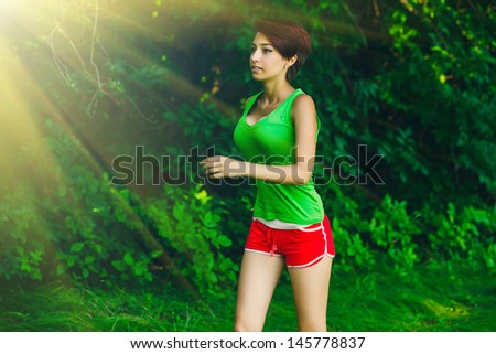 sunlight healthy beautiful young brunette woman athlete running outdoors, fitness and a healthy lifestyle, running