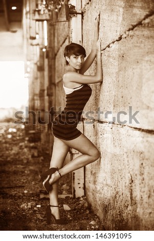 retro sepia beautiful brunette woman sexy girl standing on a city street, prostitution, slums