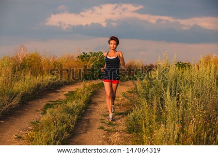 beautiful healthy runs young brunette woman athlete running outdoors, fitness and a healthy lifestyle, running