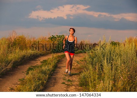 beautiful runs healthy young brunette woman athlete running outdoors, fitness and a healthy lifestyle, running