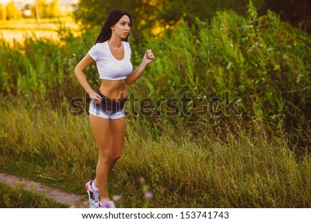 road beautiful healthy brunette young woman athlete running outdoors, fitness and healthy lifestyle, running in the forest