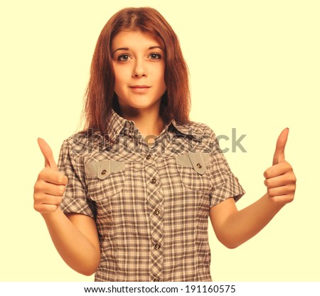 young woman brunette girl shows positive sign thumbs yes, shirt shorts isolated large cross processing retro