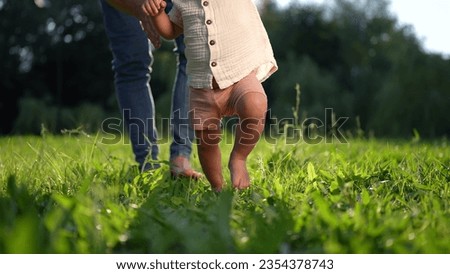 Similar – Image, Stock Photo Father with daughter barefoot on grass