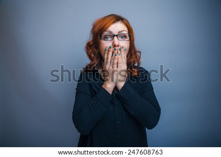 European-looking woman thirty years his hands covering her mouth, surprised
