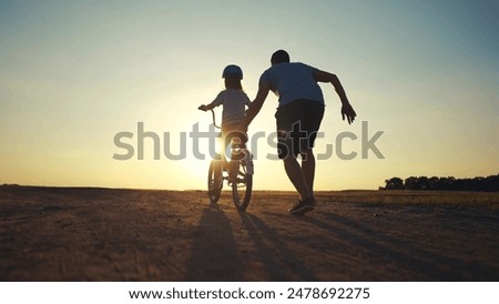 Similar – Image, Stock Photo Happy family cycling together in the countryside