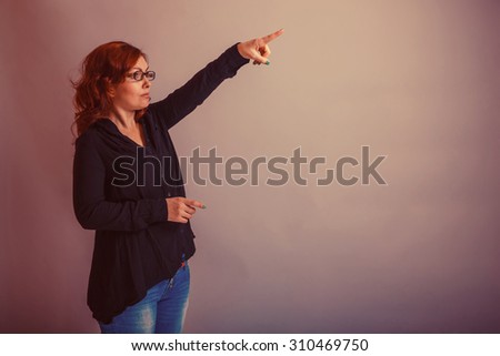European -looking  woman  of  30  years is pointing in the  direction of retro