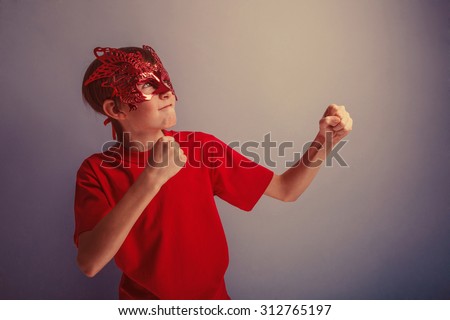 Boy teenager twelve years in  red shirt in the mask, super  hero retro