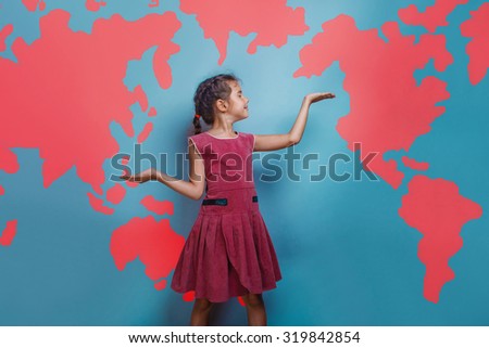 Teen girl shows gesture of hands background blank map of the world geography of science