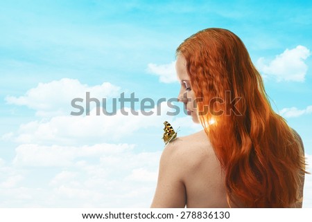 Young redhead woman with butterfly on her shoulder
