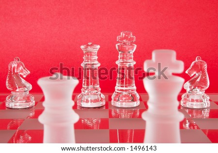 Chess game in glass.  The Queen, King and Knights as seen from the view of the Opposing Queen and King.