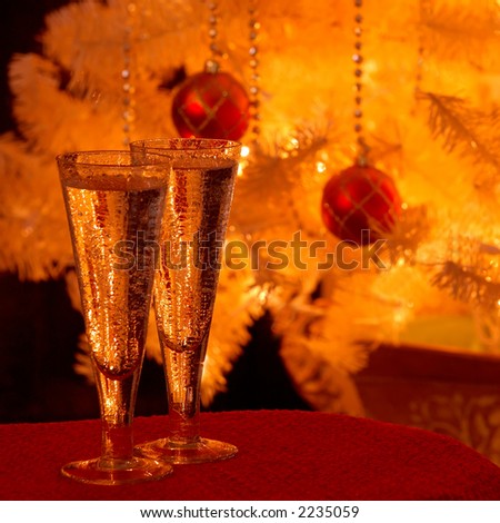 Holiday Cheer - Two glasses of wine in front of the lighted Christmas tree in the evening.
