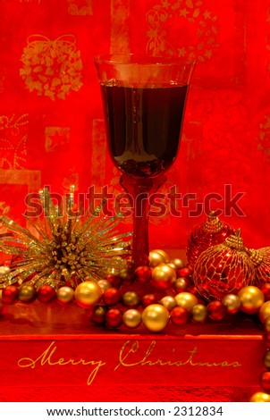 Holiday Wine - A glass of merlot wine sits among the holiday decorations.