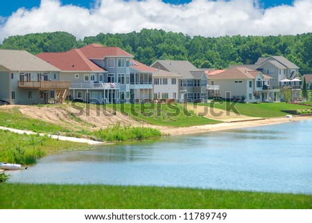 Luxury Lakeside Homes in Summer - beautiful vinyl siding vacation homes on a lake in Michigan, USA.